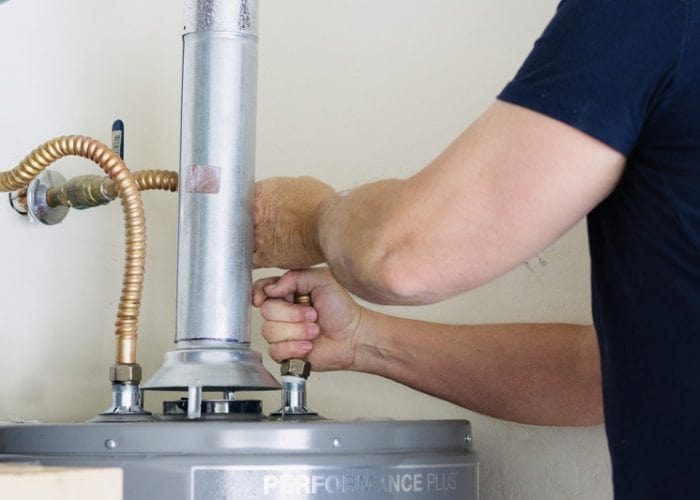 adult-male-making-adjustments-and-tightening-conne-2023-11-27-04-58-29-utc-qovajhdf3jqfsgg45bpwhsc5dpk3kou0bo8xz8nh54-min Water Heater Installation and Repair Photo